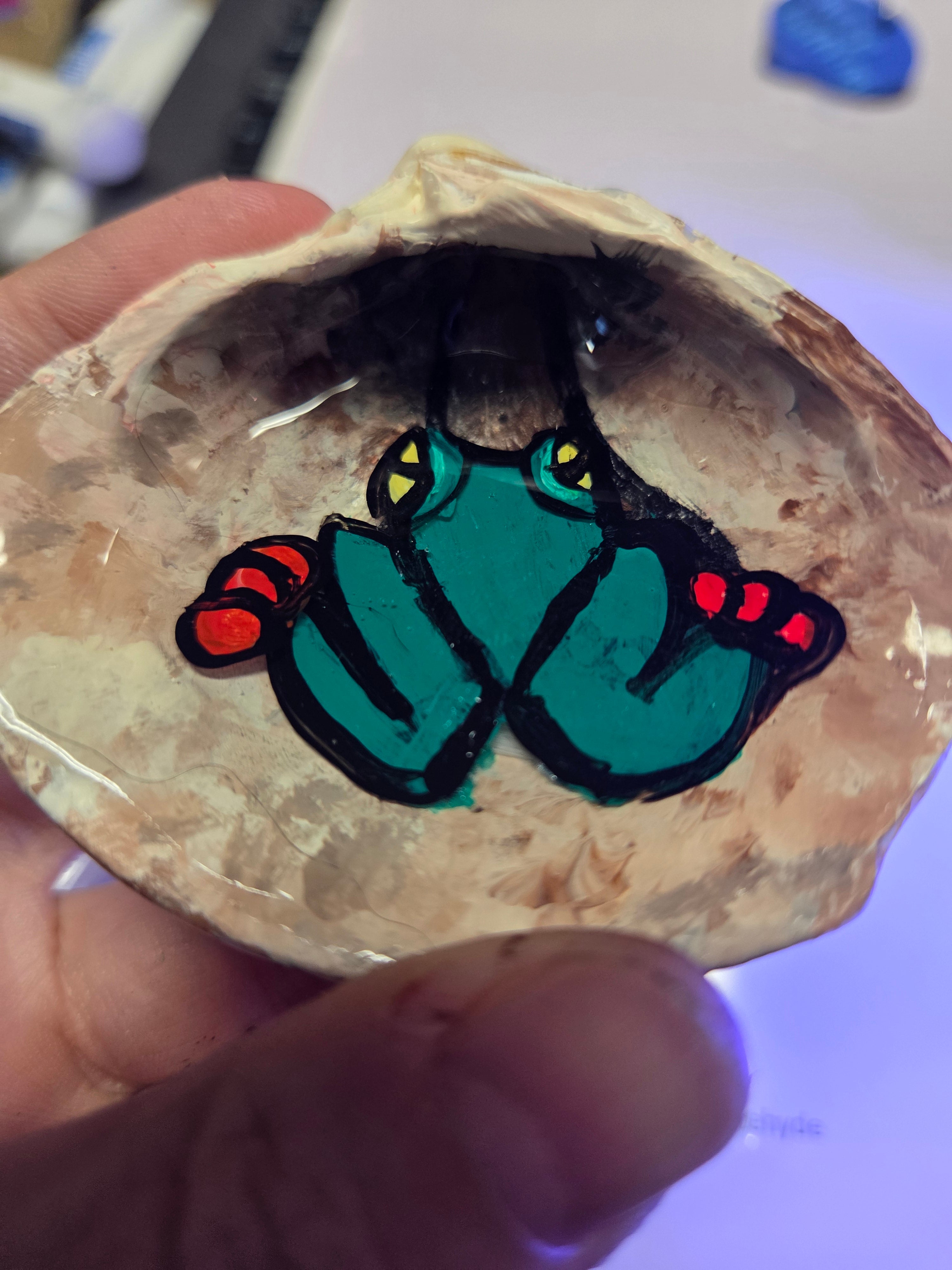 Frog on a log sea shell