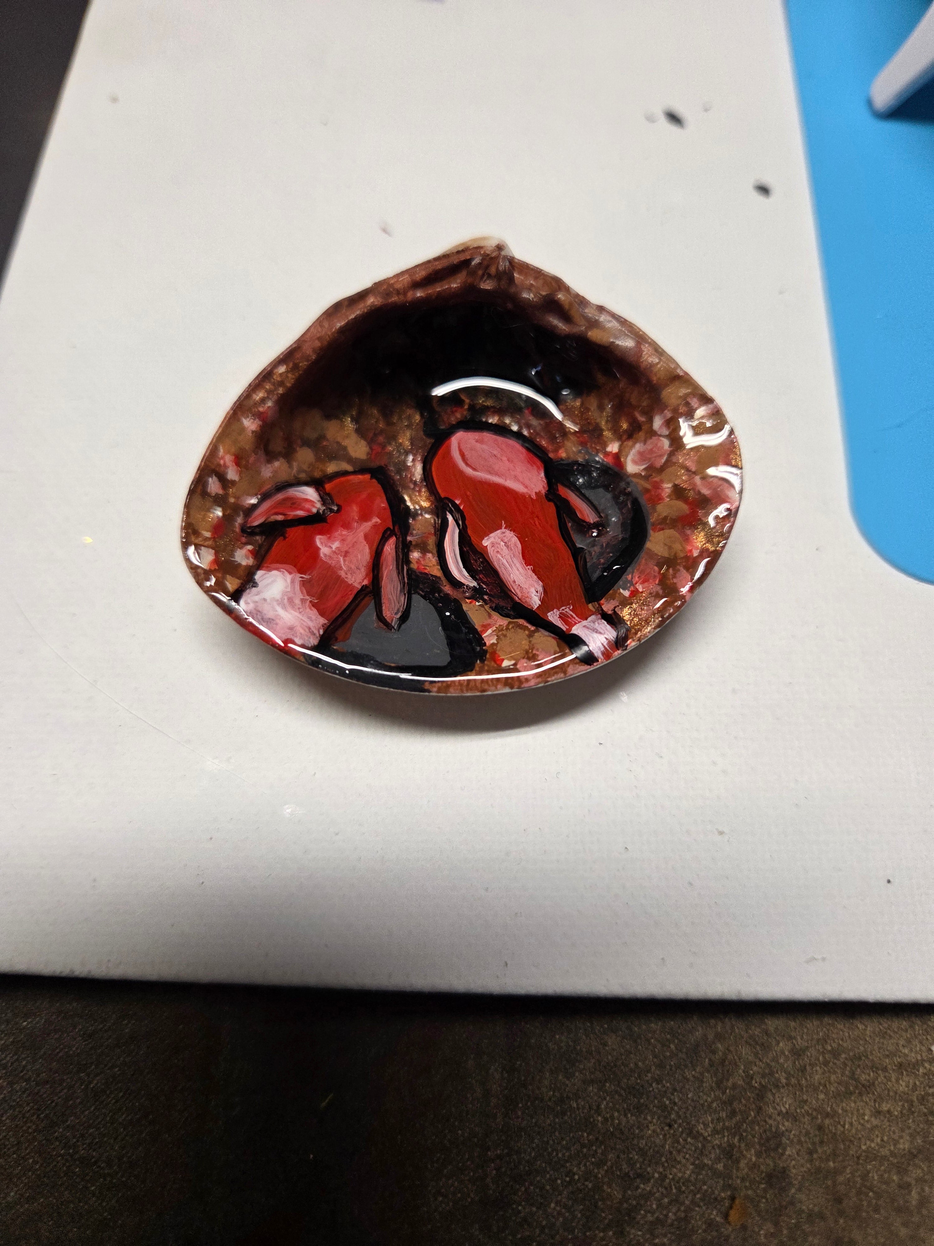 Swimming gold fish in sea shell.
